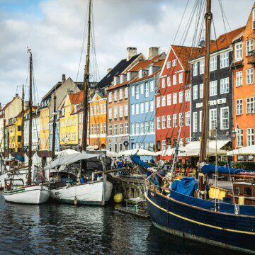 Nyhavn canal with colorful houses and tourists, a popular dining spot near vacation rentals in Copenhagen