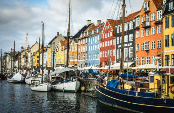 Nyhavn canal with colorful houses and tourists, a popular dining spot near vacation rentals in Copenhagen