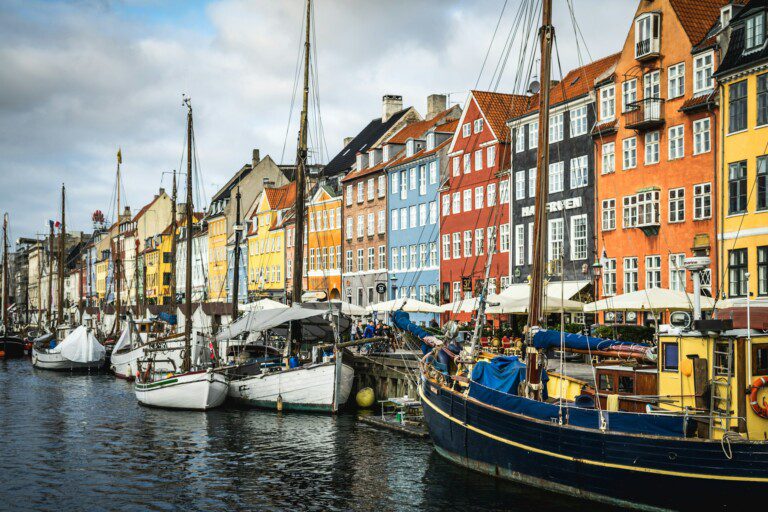 Nyhavn canal with colorful houses and tourists, a popular dining spot near vacation rentals in Copenhagen