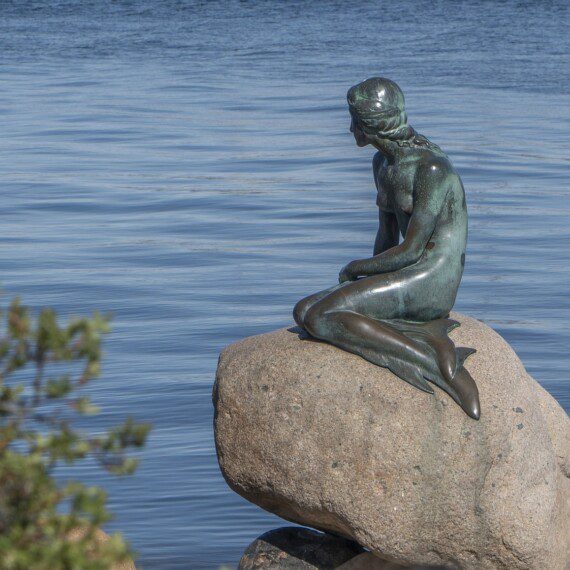 The Little Mermaid statue in Copenhagen harbour, showcasing historic charm near holiday apartments